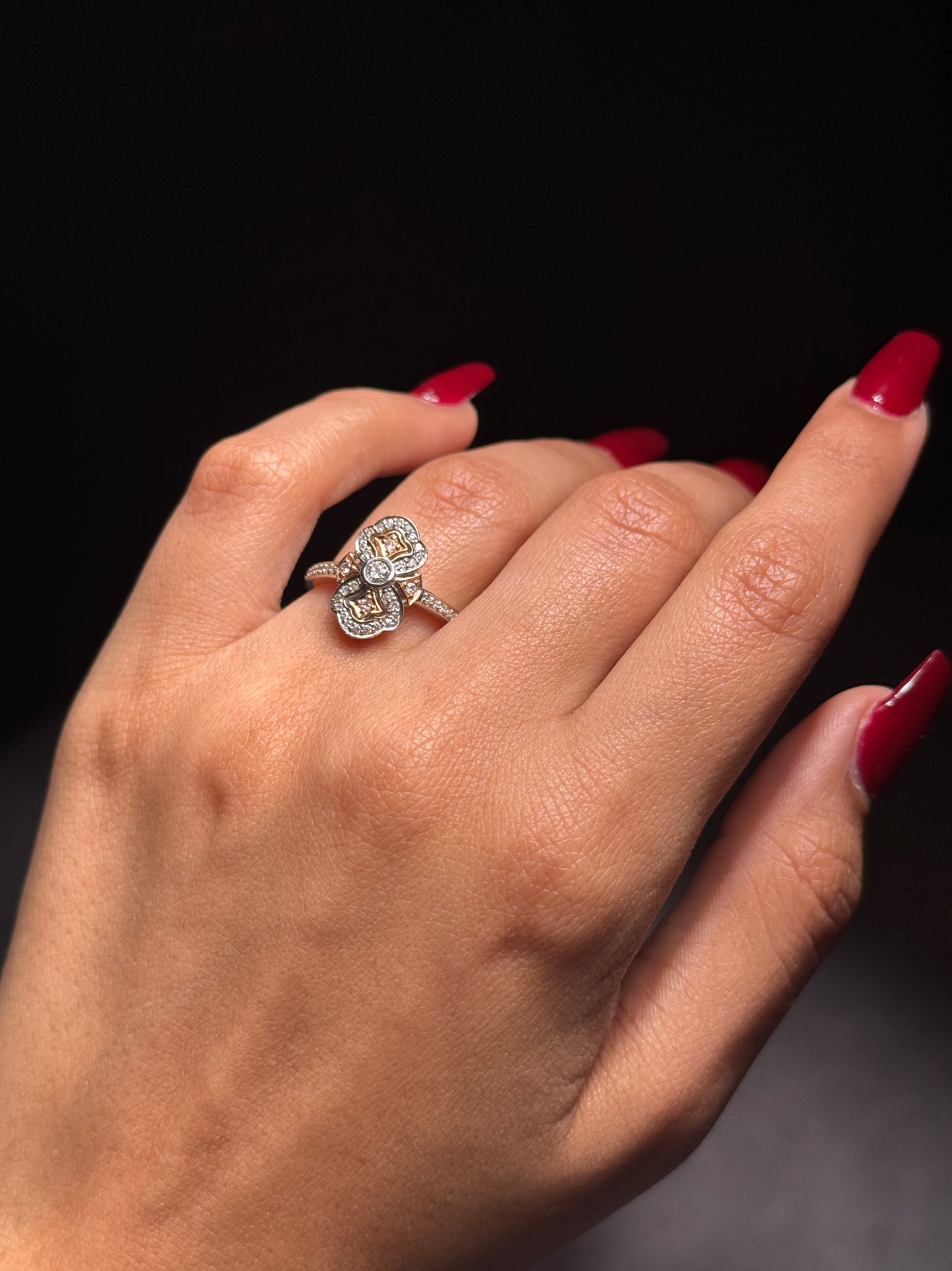Stunning claw set pink diamonds surronded by diamond halo.