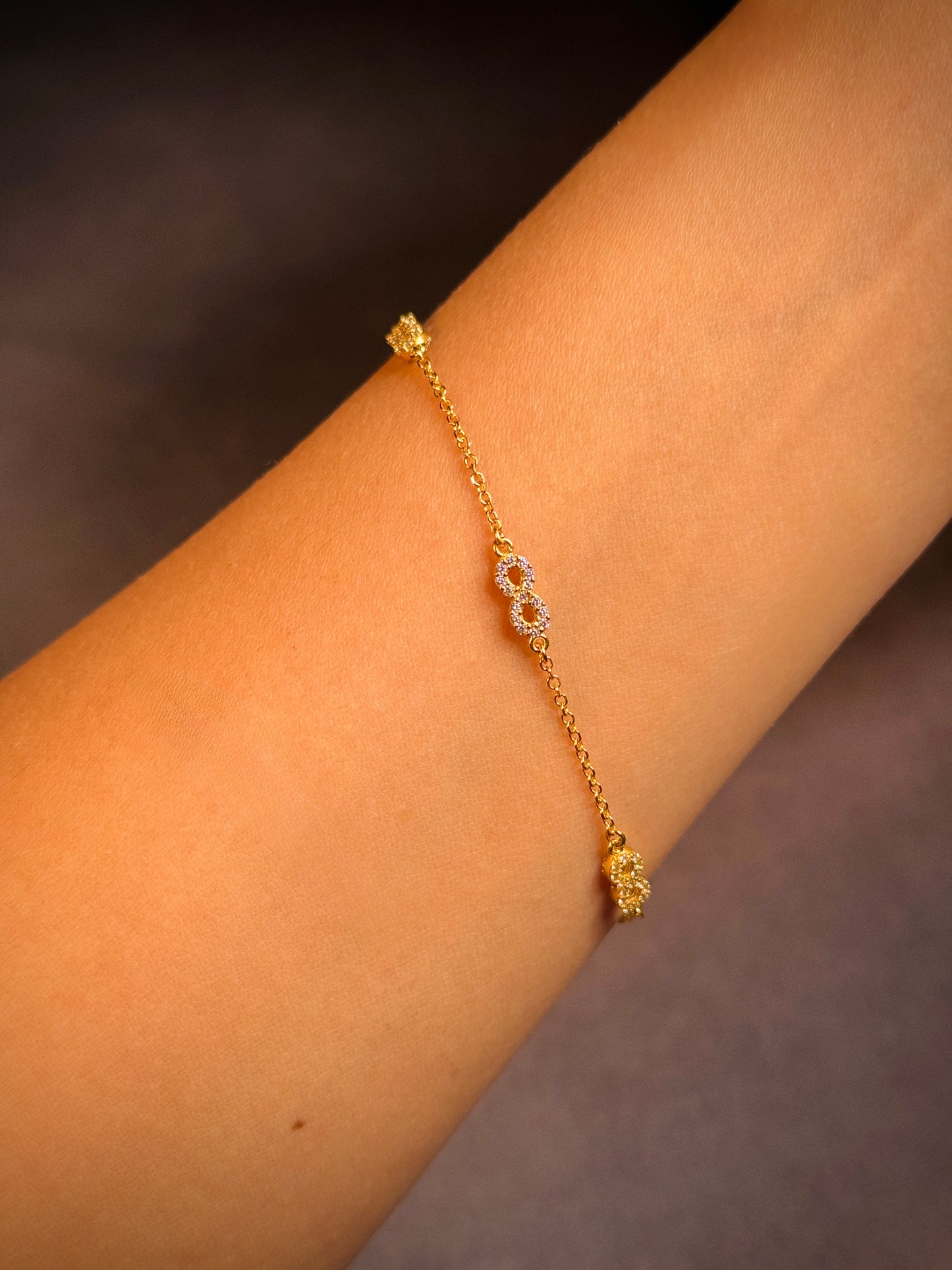 3 Cubic Zirconia Set Infinity Emblem Bracelet in 9 Carat Yellow Gold